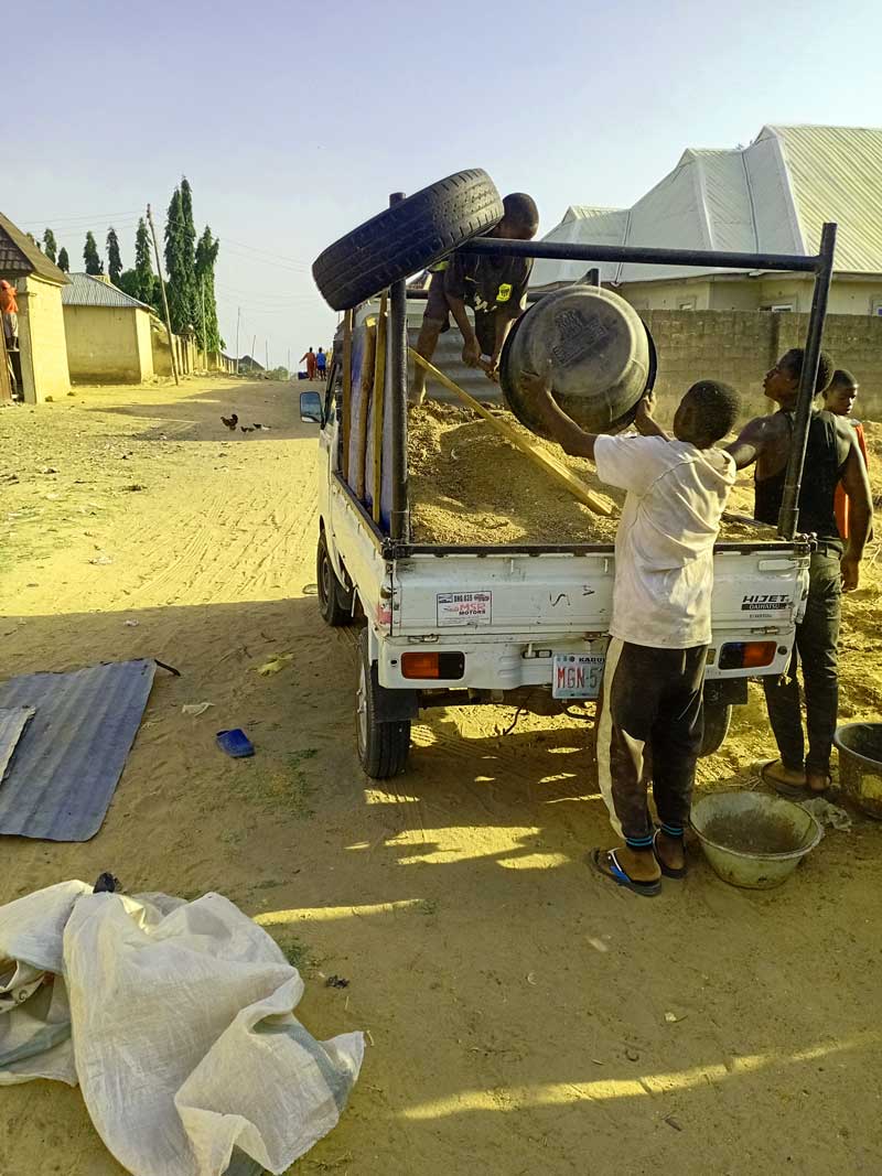 loading chicken droppings on a mini truck, for subsiquent use on the farm